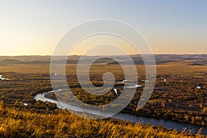 Grassland and wetland in the sunset photo