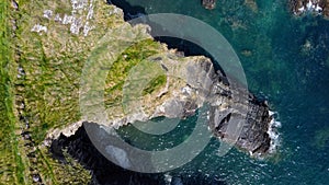 Grassy cliffs on the Atlantic Ocean coast. Landscape of Ireland from a height. Seaside rocks. Drone point of view. View from above