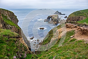 Grassy cliffs overlooking Enys Dodnan Arch