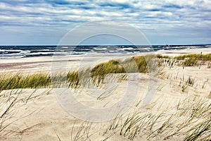 Grassy dunes and the Baltic sea at sunset