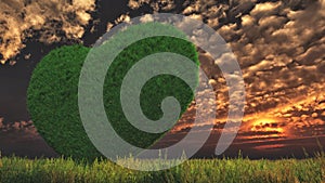 A grassy heart in a green meadow and stratus clouds in the evening.