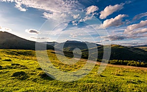 Grassy rural hillside at cloudy sunset