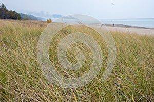 Grassy Sand Dune With Fire Plume On The Horizon