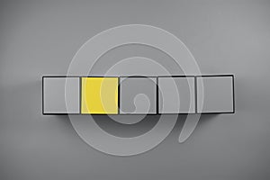 Grat and yellow cube on gray background