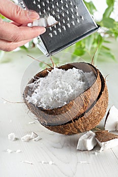 Grate coconut with grater