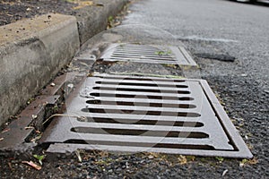 Grate of a storm sewer drain up close perspective