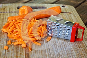 Grated carrots on a wooden surface. Unusual mystery and optical illusion