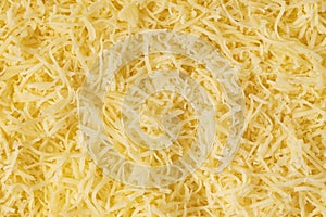 Grated cheese background texture. yellow shredded  cheese. Close up top view