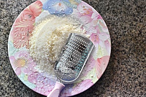 Grated cheese with blade on dish