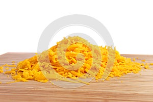 Grated cheese on cutting board