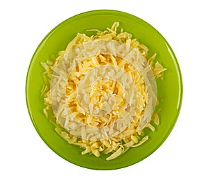 Grated cheese in green bowl isolated on white. Top view