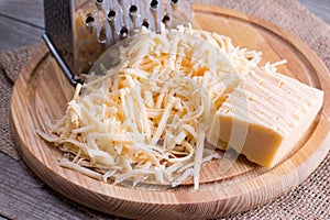 Grated cheese on a wooden cutting board