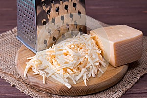 Grated cheese on a wooden cutting board