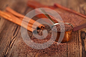 Grated dark chocolate in copper measure pan