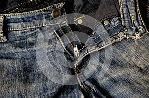 Grated jeans with a zip fastener and a button
