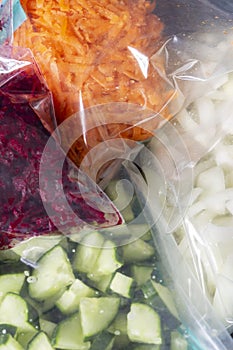 Grated and sliced vegetables, beetroot onion cucumber and carrot, in food bags