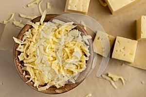 grated yellow semi-hard cheese with holes