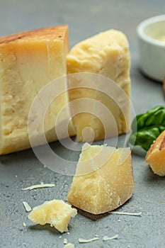 grates hard cheese on a dark background, vertical image. place for text