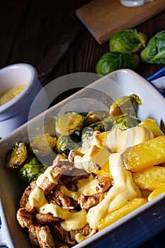 Gratinated Zurich ragout with Brussels sprouts, potatoes and Bearnaise sauce
