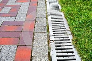 Grating of the drainage system for drainage of rainwater in the park.