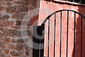 Gratings of a black metallic gate of a brick house Italy, Europe