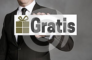 Gratis in german Free of Charge shield is held by businessman photo