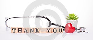 Gratitude expressing to all doctors. Close up panoramic frame view photo of doctor tools red small heart and wooden blocks with