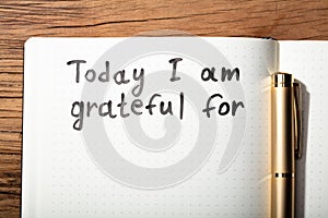 Gratitude Word With Pen On Notebook photo