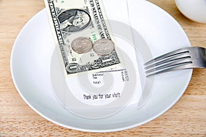 Gratuity tip on a plate