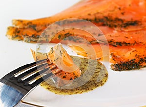Gravadlax dipped in dill sauce