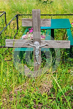 Grave cross with crucifixion in Russian provincial Cemetery