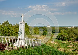 Grave with a cross in the field