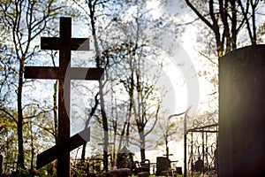 Grave cross on the Orthodox Christian cemetery at sunny day.