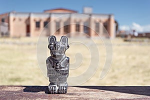 Grave statue, Andean Puma, Puma Punku.  on the background of the museum in Tiwanaku photo