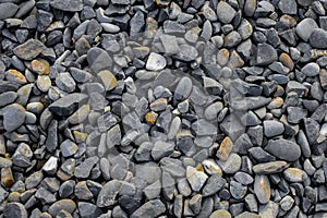 Gravel background with small and medium size gray and dark yellow stones