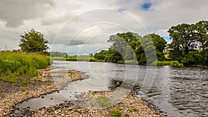 A gravel bar and low water on a lowland Scottish river in summer