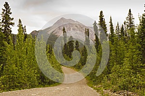 Gravel Canol road leads to a sharp mountain peak