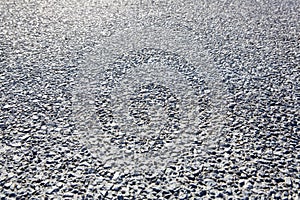 Gravel and concrete pavement used for pedestrian areas, cement works as a fixative and gravel increases grip