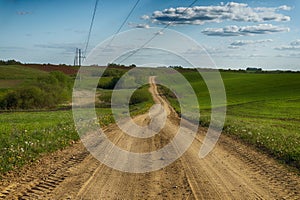 Gravel country road through farm fields