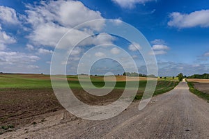 Gravel country road through farm fields