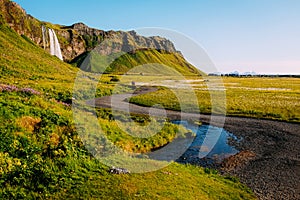 Gravel path and stream near Seljalandsfoss waterfall in Iceland