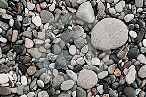 Gravel pattern of wet colored stones. Abstract nature pebbles background. Stone background. Sea peblles beach. Top view