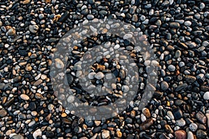 Gravel pattern of wet colored stones. Abstract nature pebbles background. Stone background. Sea peblles beach. Top view