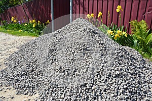 Gravel pile near hous fence for construction