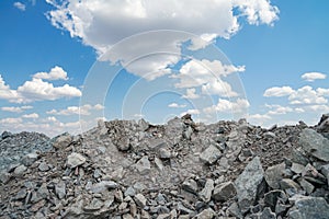 Gravel, pile of stones, on blue sky background. Top