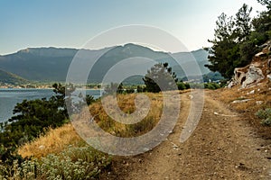 Gravel road along the Aegean seacoast Thassos island, Greece, scenic tourist destination, countryside