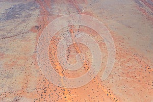 gravel road and dune stripes in Kalahari, east of Kalkrand, Namibia