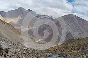 A gravel road leading through the Andes Mountain range en route to Valle de Colina, Chile, South America photo