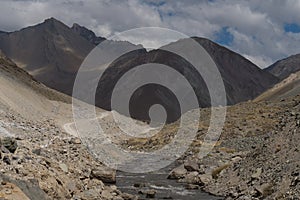 A gravel road leading through the Andes Mountain range en route to Valle de Colina, Chile, South America photo