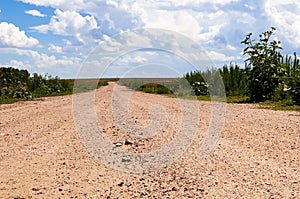 A gravel road leading toward the horizon